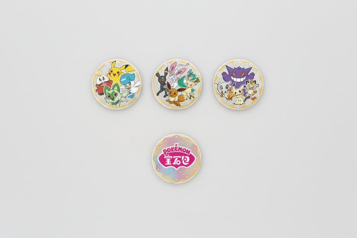 Four round badges featuring various Pokémon characters on a white background.